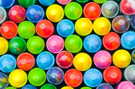 stacked color pencils close up shot showing different colors.の写真素材
