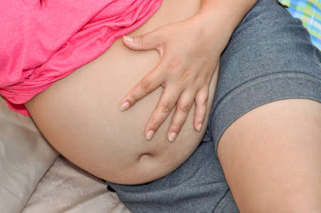 overweight woman with big bellyの写真素材