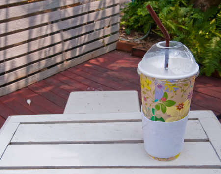 Paper coffee cup on a wooden table.の写真素材