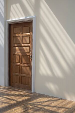 Side view of wooden door in mastic color cement wall with sunlight and shadow of roof structure on wood floor tiles surface inside of house building site in vertical frameの写真素材