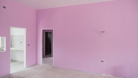 Dimension and perspective view of 3 door frames on pink cement wall in various corners inside of incomplete house construction site, selective focusの写真素材