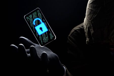 Close up illuminate unlock icon with green binary code on screen of smartphone floating above of...