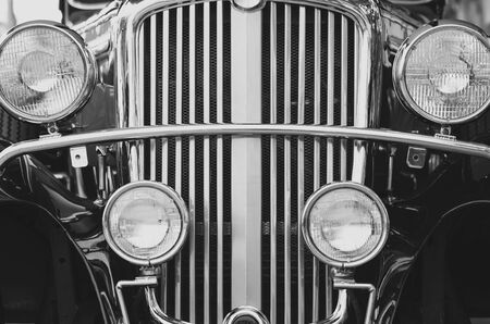 Close up front headlights with sparkle chrome of the old vintage classic car in black and white...