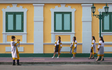 Bangkok, Thailand - August 29,2020 : Young Asian college students group in graduation gowns are...