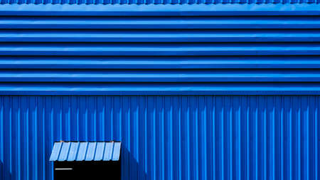 Aluminum louver and opened steel window on blue warehouse building wallの写真素材
