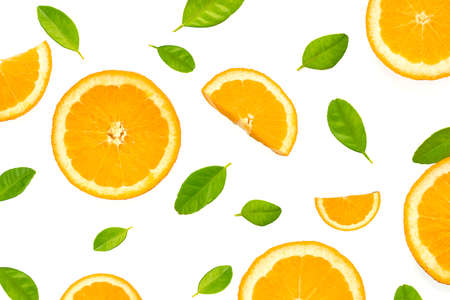 Flat lay of orange slices with green leaves on white background