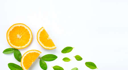 Creative layout orange slices with green leaves on white background, flat lay with copy space for textの写真素材