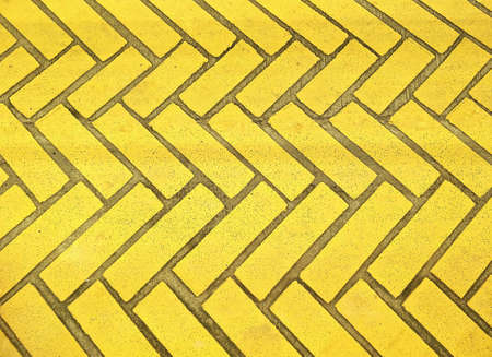 The old yellow bricks stone floor with zigzag pattern texture background for sidewalk decorations...