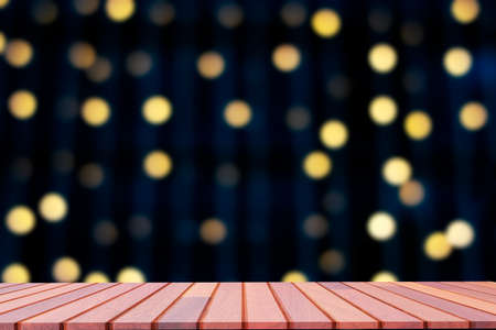 Empty wooden board mock up with blurred abstract hanging decorative lights and bokeh in night...
