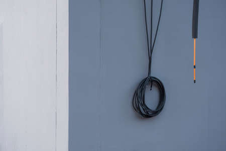 Perspective side view of air conditioner ducts with insulation and electrical wires on gray cement wall in house construction site, installation and renovation conceptの写真素材