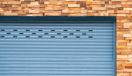 Front view of roller shutter door on timber wall background