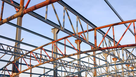 Low angle view of metal roof structure for install on top of building structure in construction site areaの写真素材