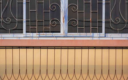 Abstract background pattern of the old wrought iron balustrade with window grill on terrace of...