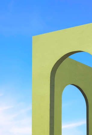 Abstract architecture background of green Tuscany arches wall against blue sky in perspective side view and vertical frameの写真素材