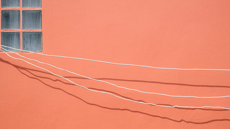 Minimal simplicity background of electrical cables are temporarily installed on brown wall for...