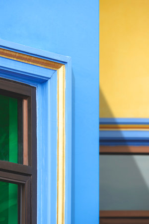 Abstract colorful geometric pattern of glass window on vintage building wall background in...
