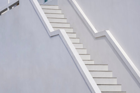 Background of white staircase with concrete railing outside of modern buildingの写真素材