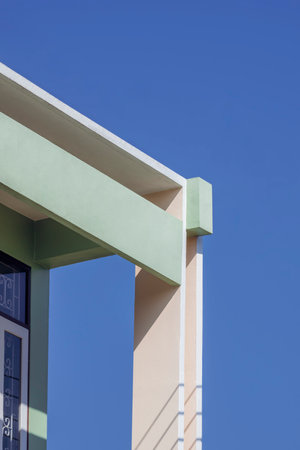 Sunlight on surface of rectangle pillar and shading fin concrete with roof awning on green and beige...