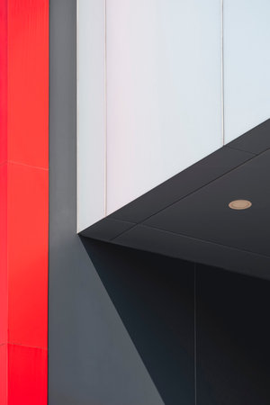 Street minimal architecture Background, Sunlight on surface of multicolor aluminum composite tile wall of modern building in vertical frameの写真素材