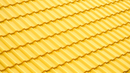 Modern yellow ceramic tile roof with light reflection on surface in perspective side viewの写真素材