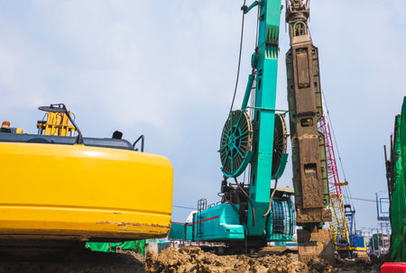 Drilling crawler crane with hydraulic diaphragm wall equipment of boring machine working on highway in road construction site for elevated road construction projectの写真素材