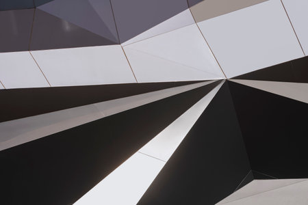 Light and shadow on geometric pattern surface of decorative aluminum composite tiles wall outside of...