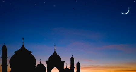 Silhouette Mosque domes with Crescent moon and stars on Twilight sky background in Iftar period during Ramadan Holy monthの写真素材