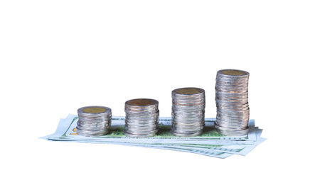 Columns of coins stack on dollar banknotes on isolated white background with clipping pathの写真素材