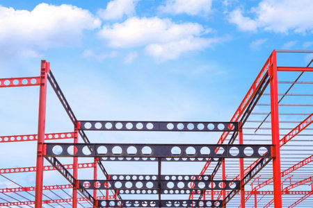 Red and black Castellated Beam metal of Industrial Building Structure in Construction Site against...