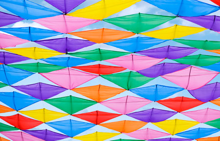 Outdoor entertainment event decoration Background of Colorful decorative fabric hanging on the air against blue skyの写真素材