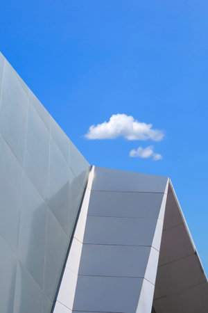 Minimal Exterior Architecture Background. Part of gray Aluminum Composite tile Wall outside of Modern Building against blue sky in vertical frameの写真素材