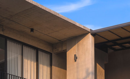 Sunlight and shadow on balcony of the old modern loft house with blue sky in low angle and...