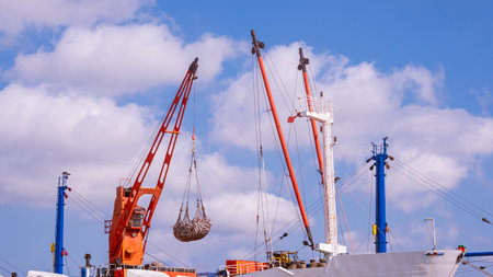 Crane on large fishing boat is transferring tuna fish into trucks at the commercial portの写真素材