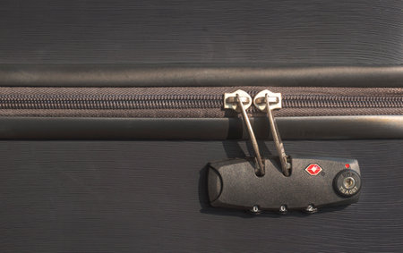 Close up of TSA accepted security lock with zip on modern black suitcase or luggage bagの写真素材