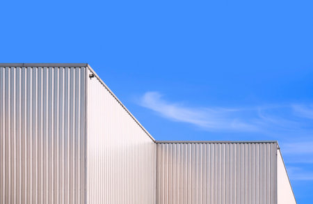 Aluminium Corrugated Industrial Building against blue sky Background in low angle and Perspective side viewの写真素材