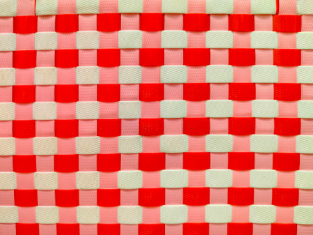 Colorful red and white weave pattern background of recycled plastic basket, recycle concept