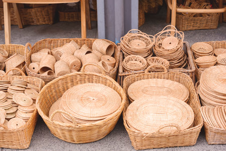 Group of many various handmade wicker products for sale on the floor in street market at Thailandの写真素材
