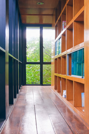 Bookshelf with steel and glass wall inside of vintage library room in perspective view and vertical frameの写真素材