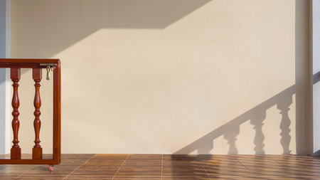 Sunlight and shadow on mastic yellow cement wall surface with balustrade in porch area of vintage house, interior architecture conceptの写真素材