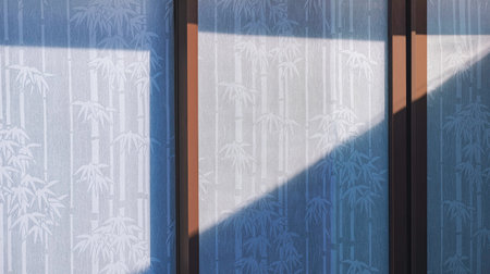 Sunlight and shadow on surface of white mulberry paper sunshade curtain with bamboo tree pattern behind glass wall inside of roomの写真素材