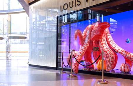 Bangkok, Thailand - May 26,2023 : Colorful dancing pumpkin and products with multimedia in showcase display in front of Louis Vuitton store at Siam Paragon shopping mallのeditorial素材