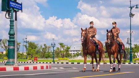 Bangkok, Thailand - October 13, 2023 :Two mounted policemen are riding horses to security inspections on the road in front of the Grand Palaceのeditorial素材