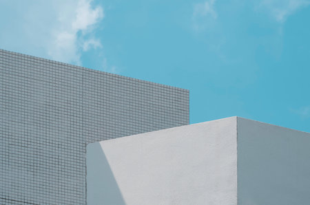 Geometric exterior architecture minimal background of the old white house building against pale blue sky in street photography styleの写真素材