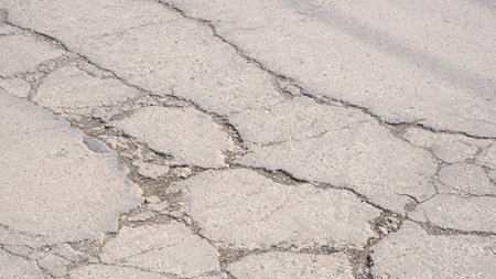 The old damaged concrete road background with broken and crack texture on surfaceの写真素材