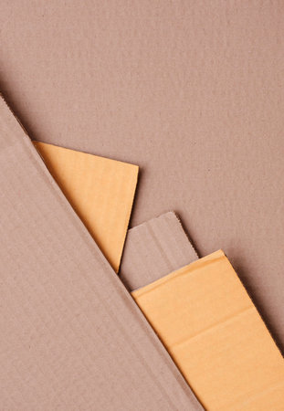Part of 5 Cardboard sheets stacked in geometric pattern background in vertical frame, Top view with copy spaceの写真素材