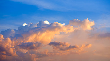 Sunset sky with orange sunlight and amazing clouds shape on horizon blue evening sky background