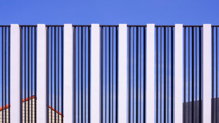 Empty modern billboard display structure in front of the housing development against blue sky backgroundの写真素材