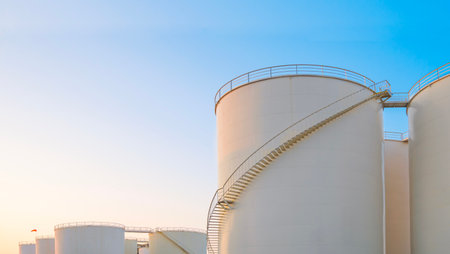 Group of Storage Fuel Tanks in Oil Industrial Yard area against blue Evening Sky background, Low...