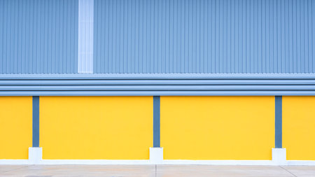 Steel louver ventilation on gray aluminum corrugated metal and yellow cement wall of Industrial...