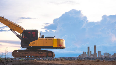 Excavator parked on the ground with many precast concrete piles in industrial building construction...